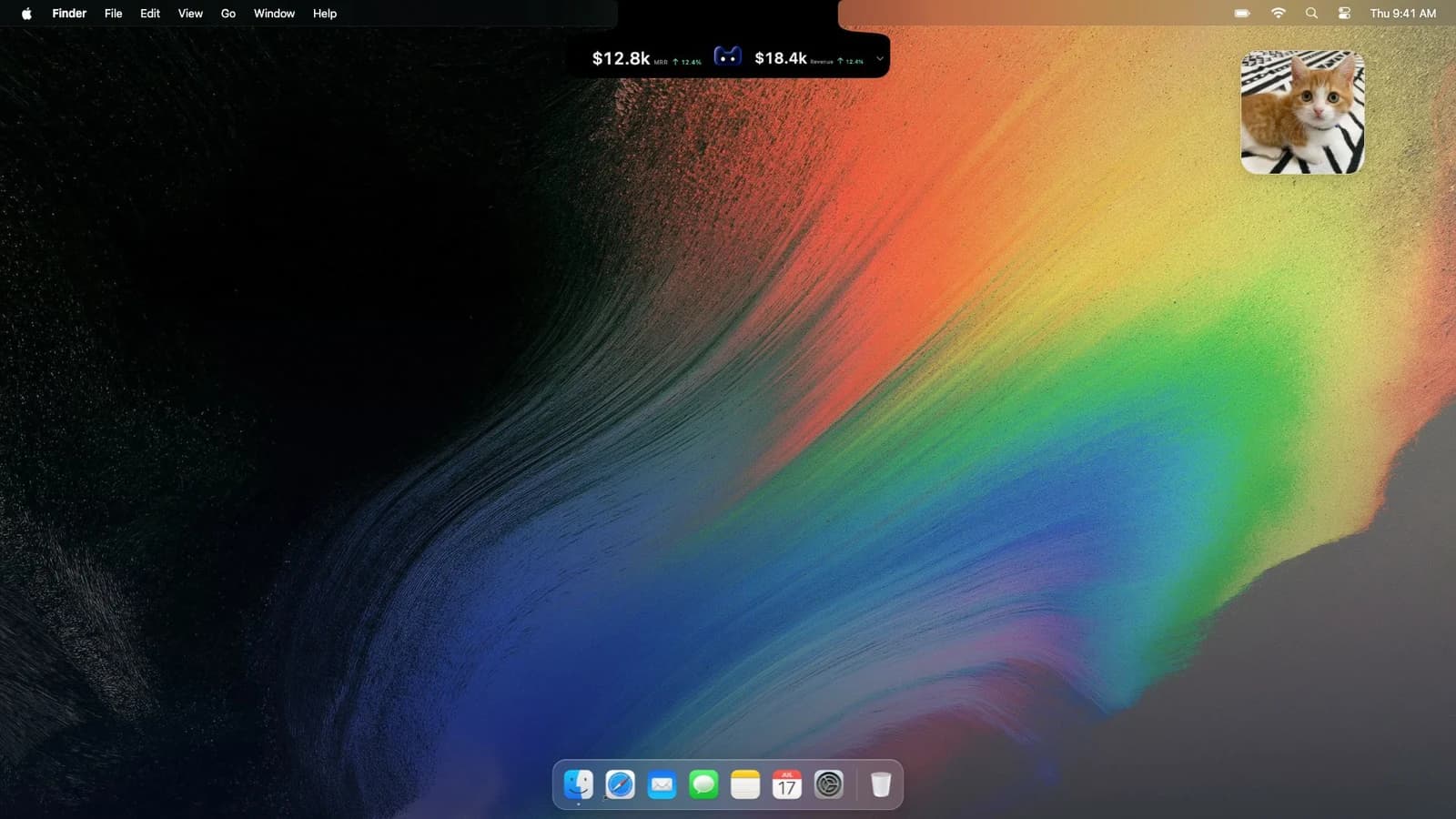 Desktop preview with a compact revenue dashboard attached to the notch at the top of the screen